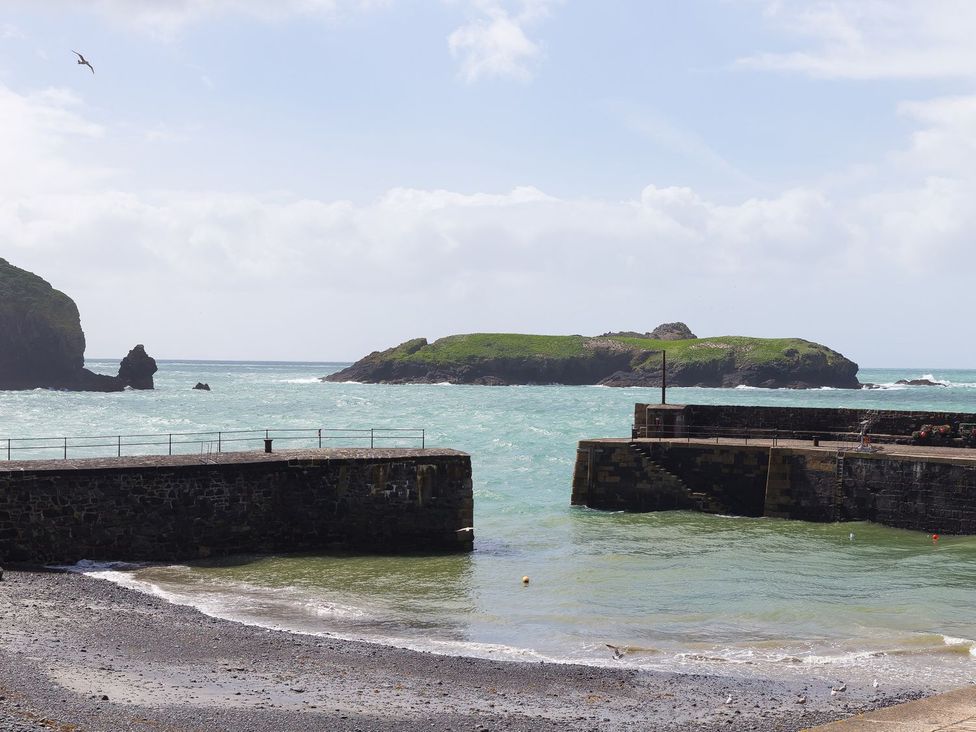 A view of the sea and an island from a pier at Verity in Mullion