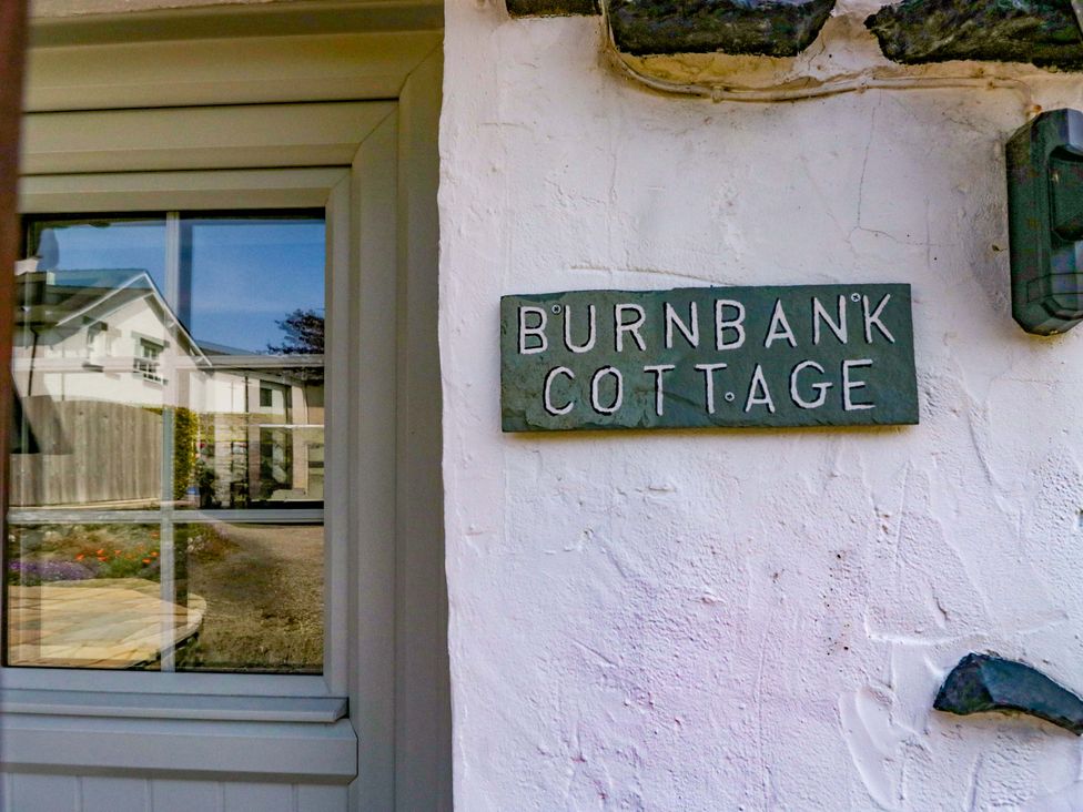 A sign for Burnbank Cottage on a wall