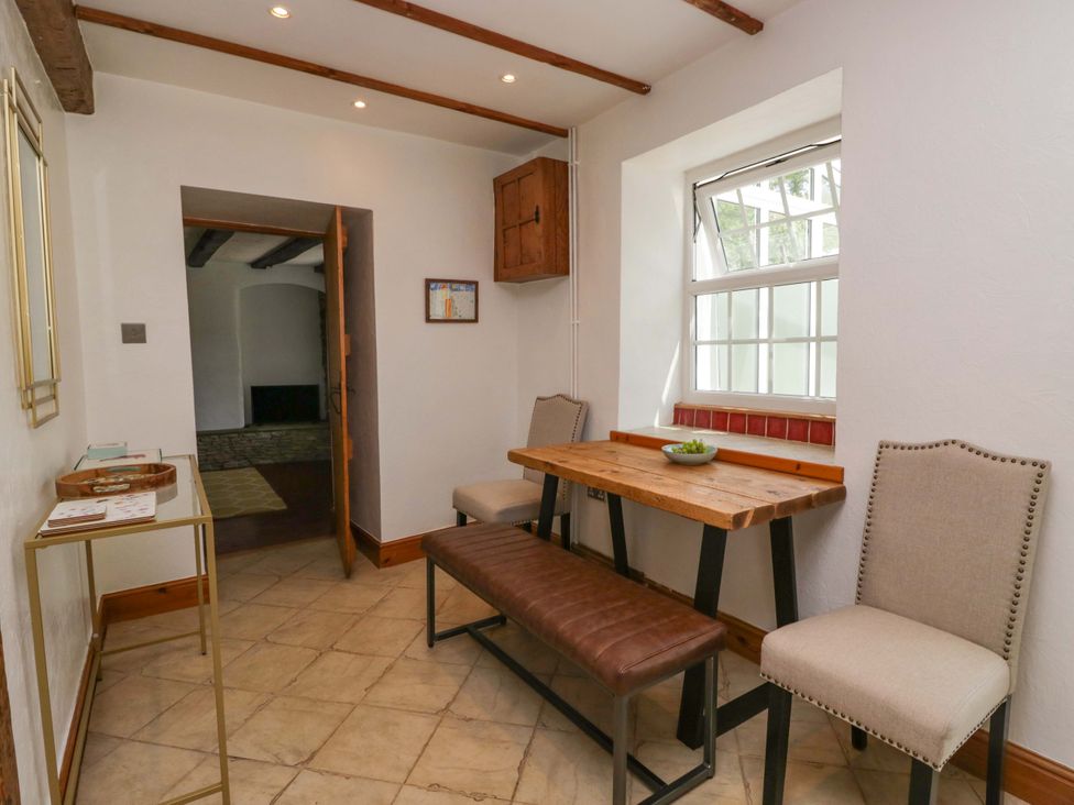 A dining room with a table and chairs at Burnbank Cottage in Grange-Over-Sands