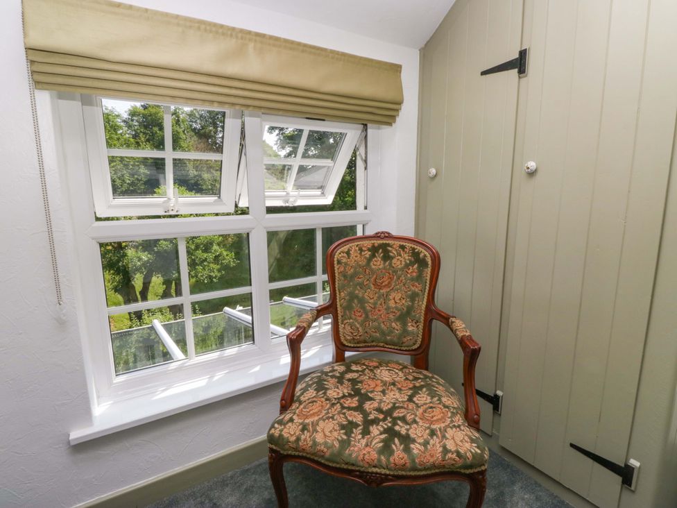 A small study with a chair and a window at Burnbank Cottage in Grange-Over-Sands