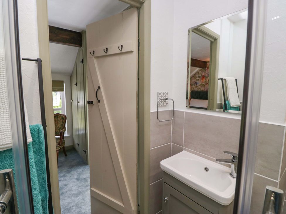A bathroom with sink and mirror at Burnbank Cottage in Grange-Over-Sands