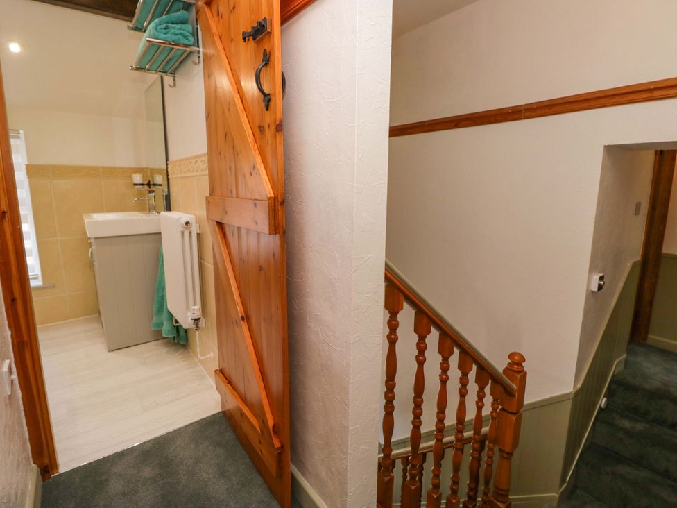 A bathroom with a sink and towels at Burnbank Cottage in Grange-Over-Sands