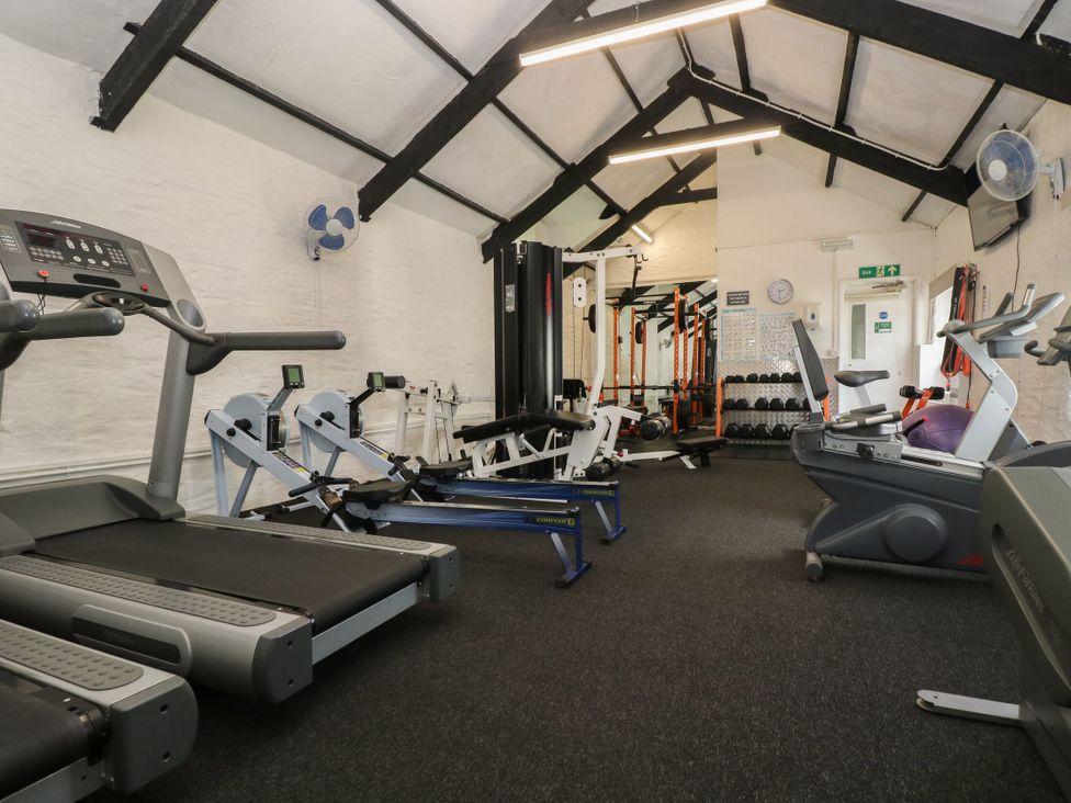 A gym room with treadmills rowing machines weightlifting equipment and exercise bikes at 37 Tamar in St Ann's Chapel near Callington