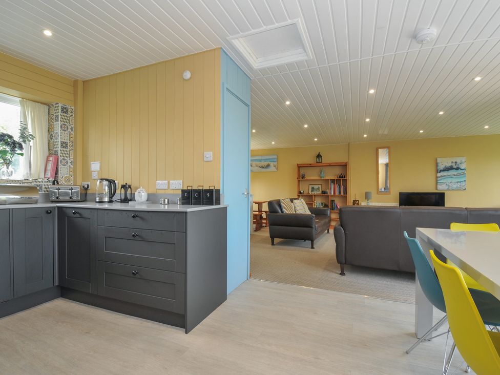 A kitchen and living area with furniture at 37 Tamar St Ann's Chapel near Callington