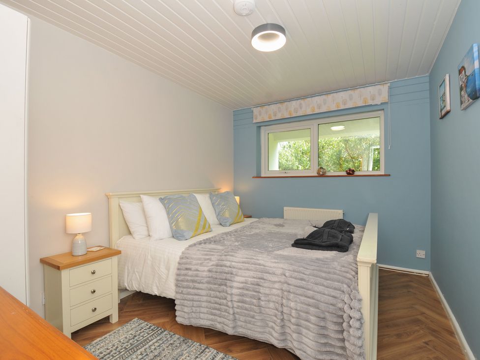 A bedroom with a bed and nightstand at 37 Tamar St Ann's Chapel near Callington