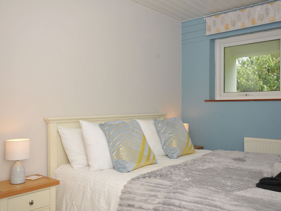 A bedroom with a bed and pillows at 37 Tamar St Ann's Chapel near Callington