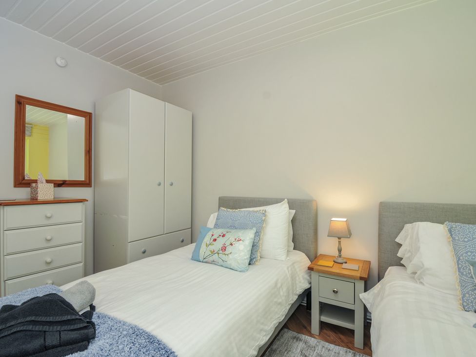 A bedroom with two beds and storage furniture at 37 Tamar in St Ann's Chapel near Callington