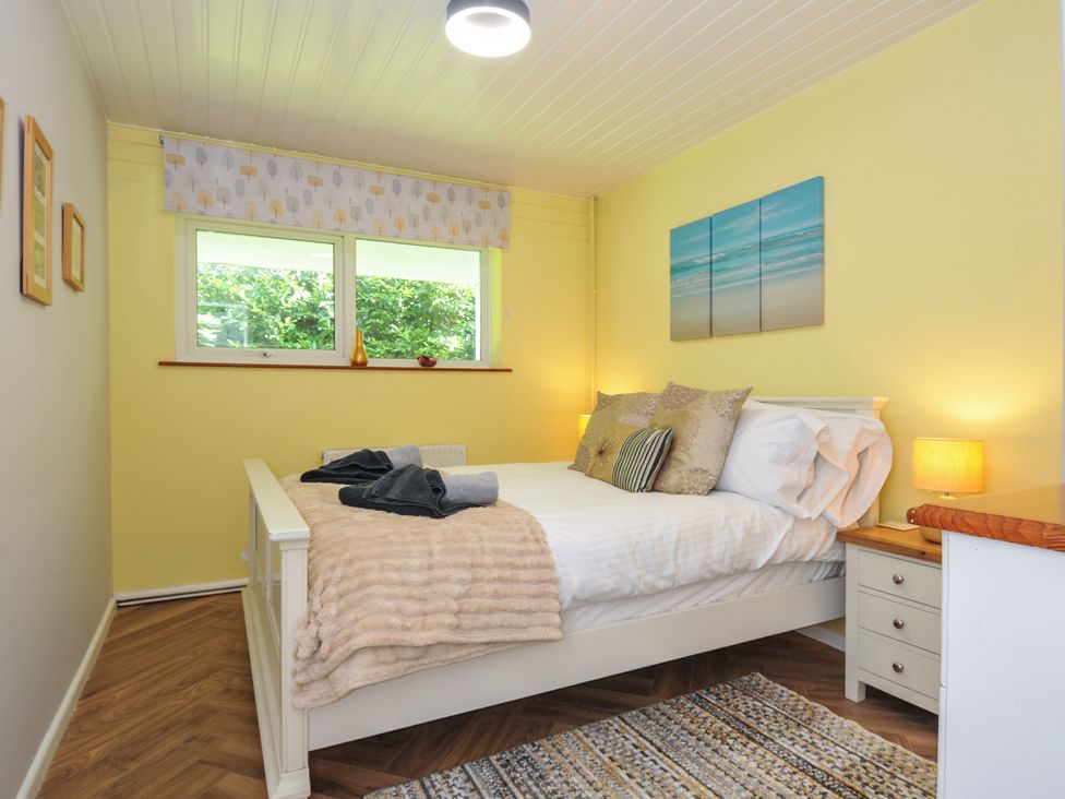 A bedroom with a bed and nightstand at 37 Tamar St Ann's Chapel near Callington