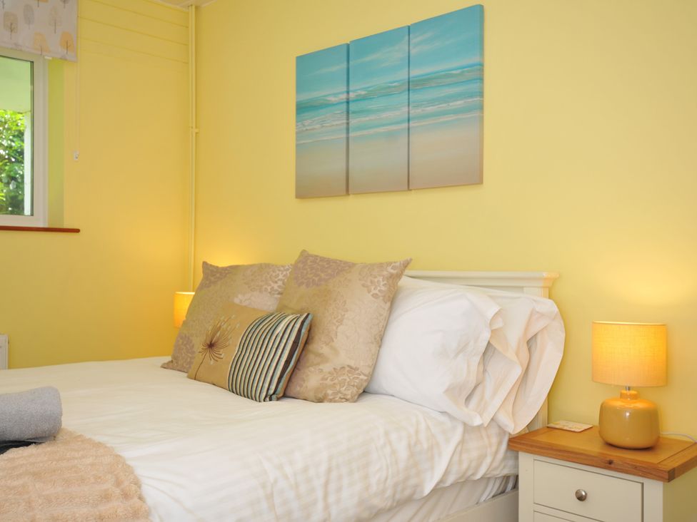 A bedroom with a bed and pillows at 37 Tamar in St Ann's Chapel near Callington
