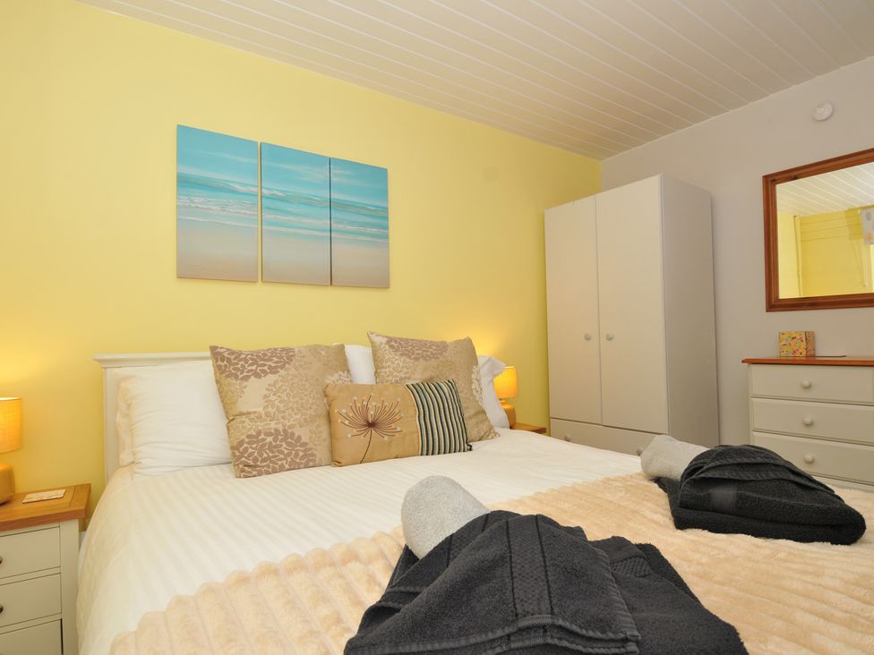 A bedroom with a bed and wardrobe at 37 Tamar St Ann's Chapel near Callington