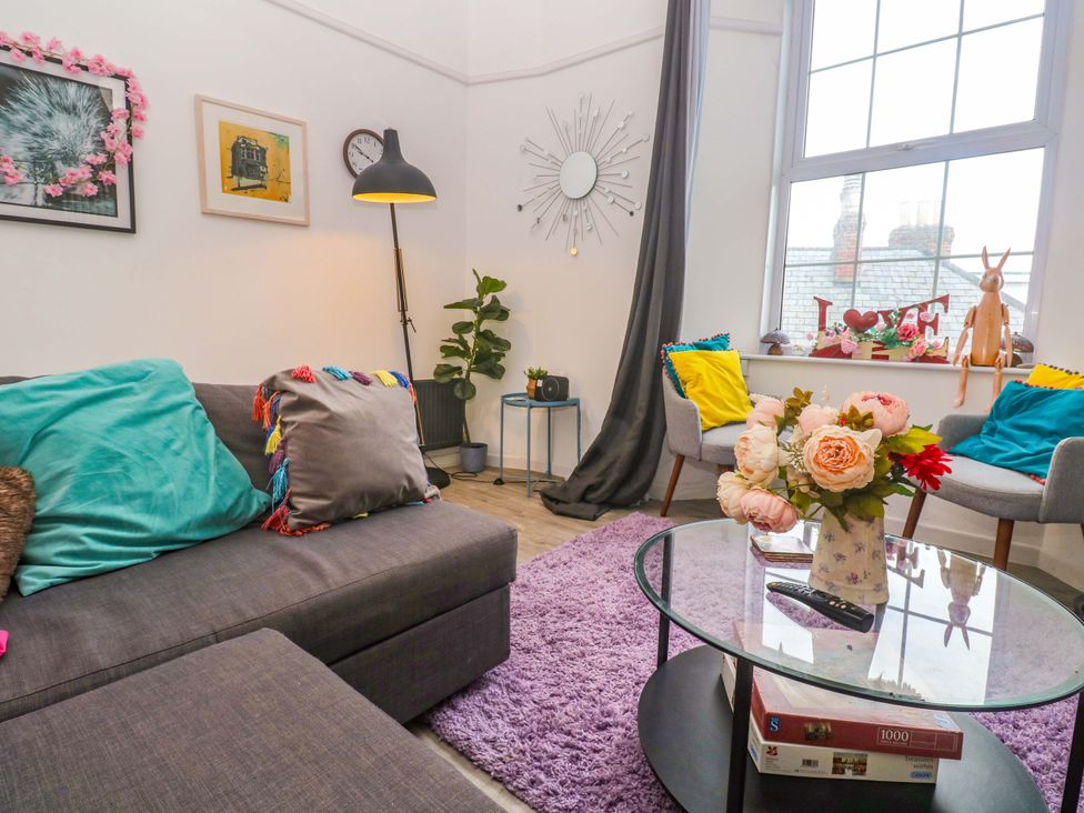 A living room with a sofa and a coffee table at Harbour View St Ives