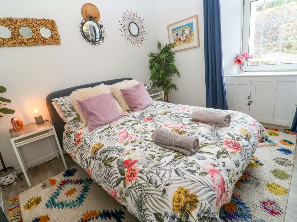 A bedroom with a bed and decorative elements at Harbour View in St Ives