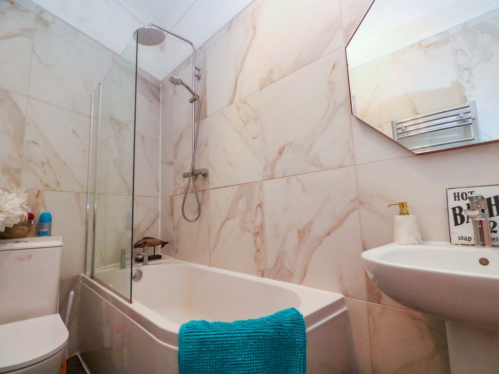 A bathroom with a bathtub and shower at Harbour View in St Ives