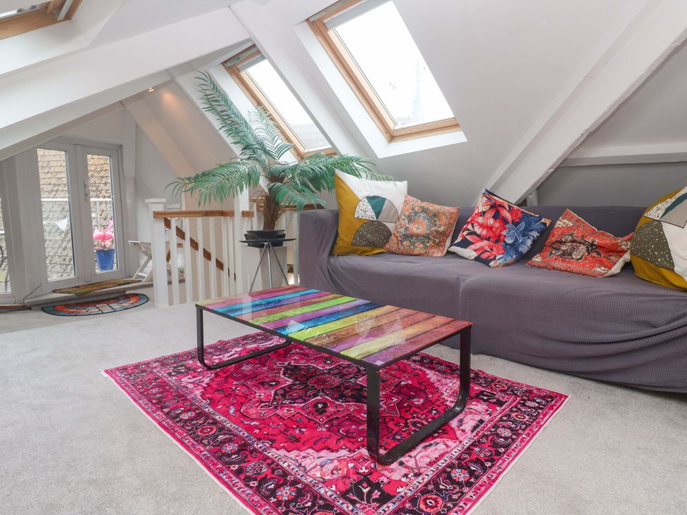 A living room with a sofa and coffee table at Harbour View St Ives