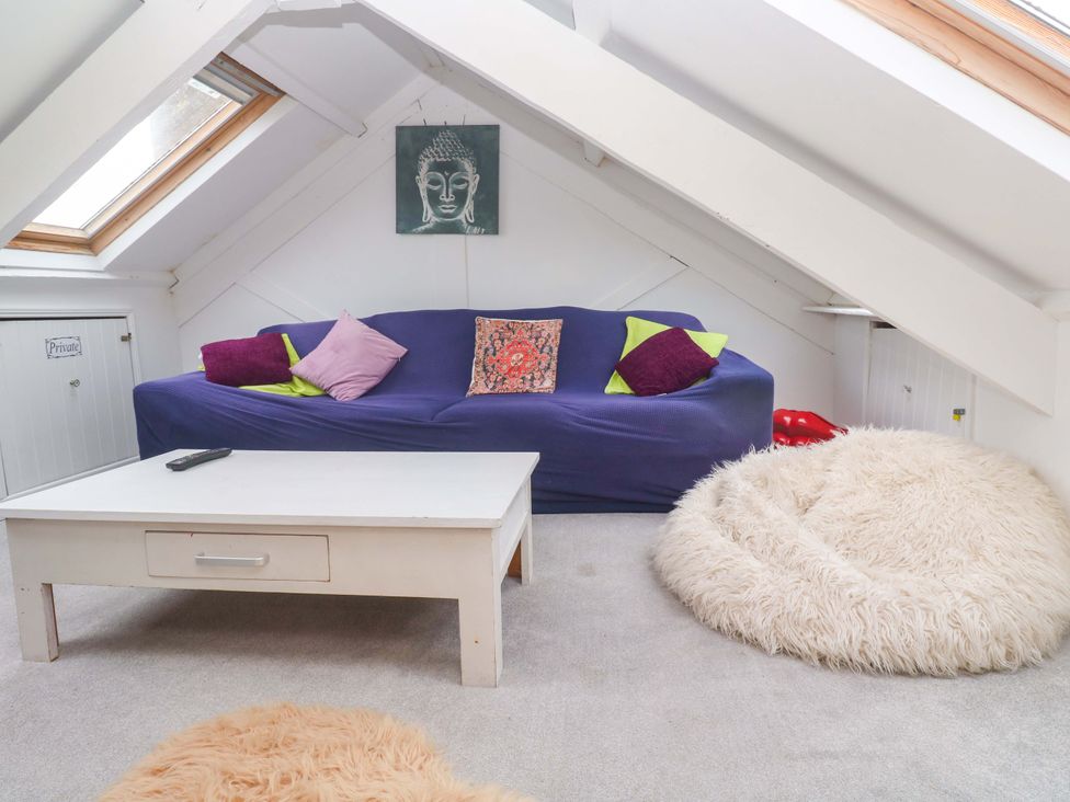 A seating area with a sofa and coffee table at Harbour View in St Ives