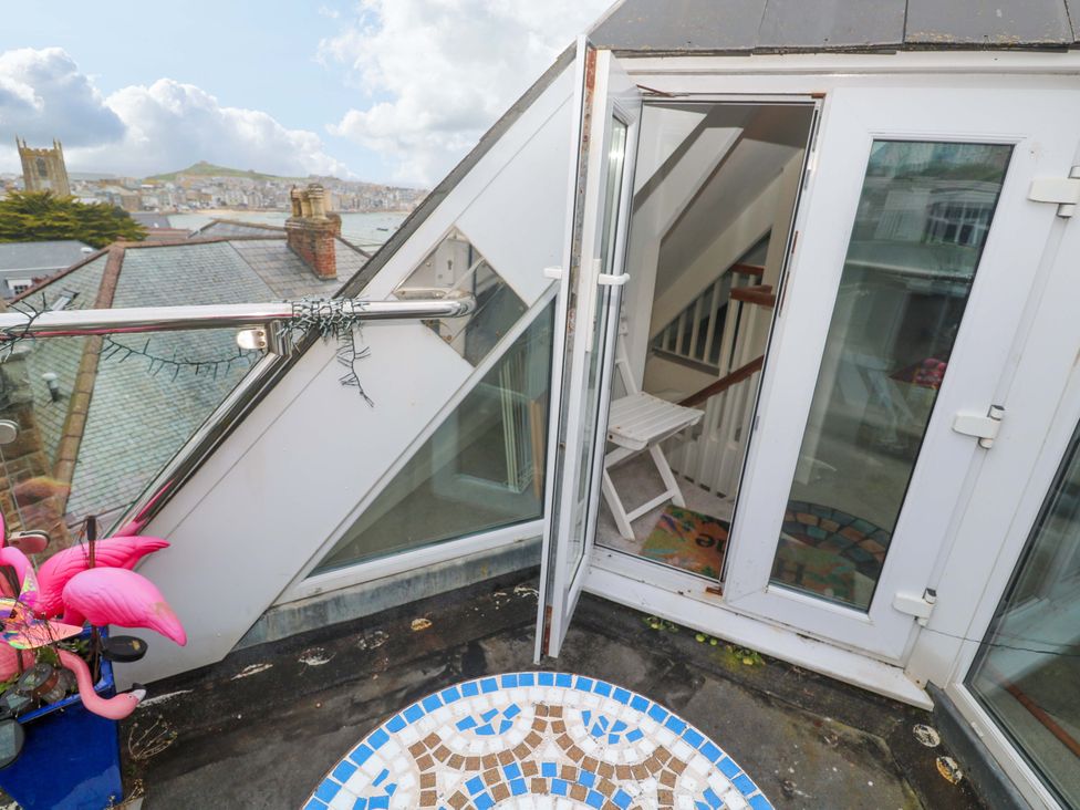 An outdoor terrace with a staircase and seating at Harbour View in St Ives