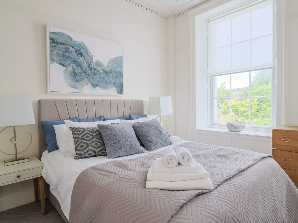 A bedroom with a bed and window at FLAT 1 53a Broad Street (1 Bedroom Sleeping 2) Lyme Regis