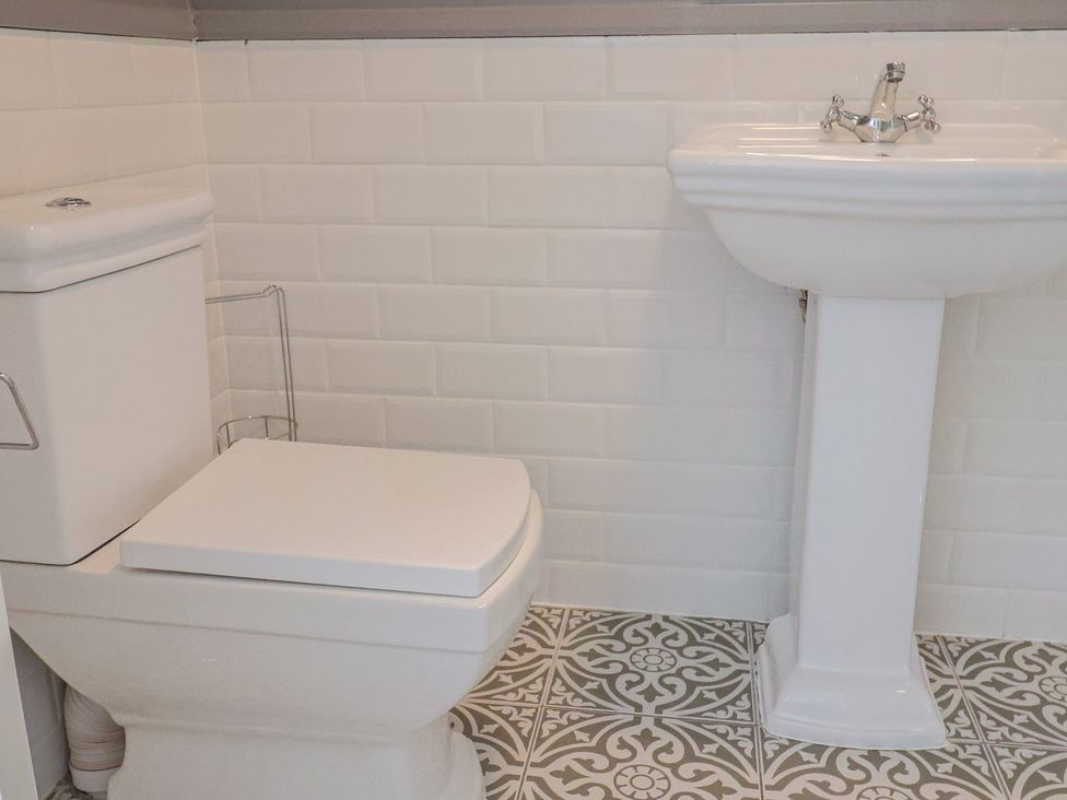 A bathroom with a toilet and sink at FLAT 1 53a Broad Street (1 Bedroom Sleeping 2) Lyme Regis