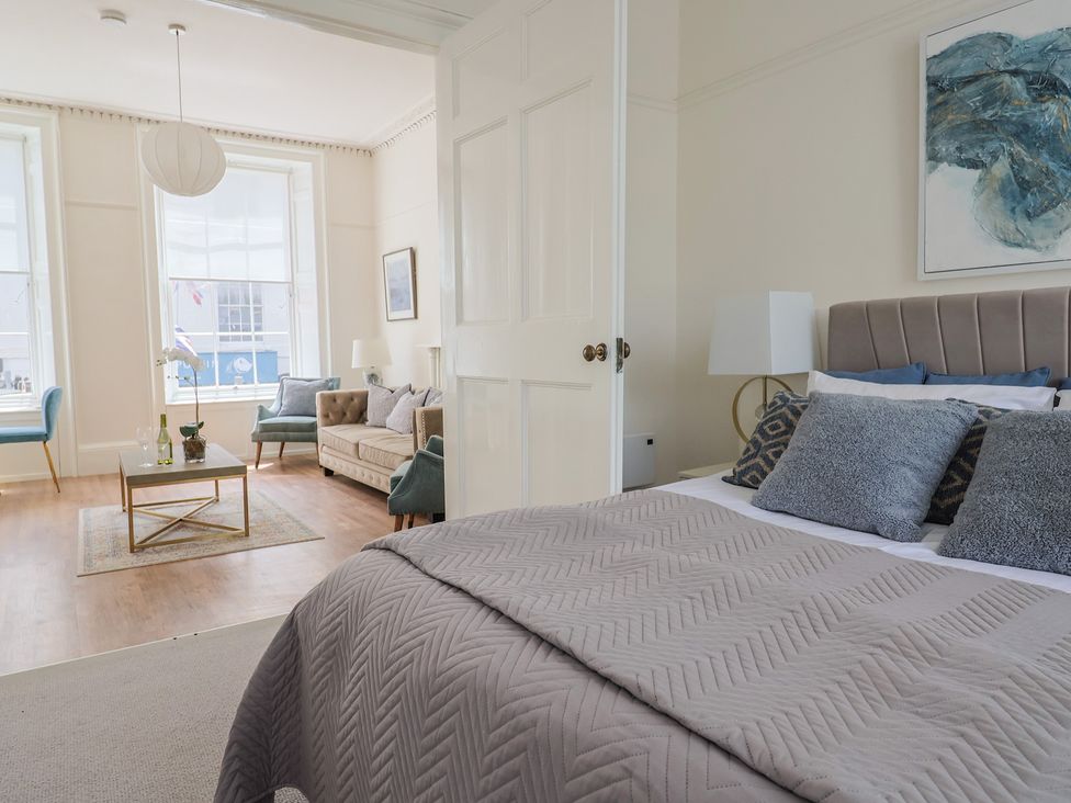 A bedroom with a bed and a seating area at FLAT 1 53a Broad Street (1 Bedroom Sleeping 2) Lyme Regis