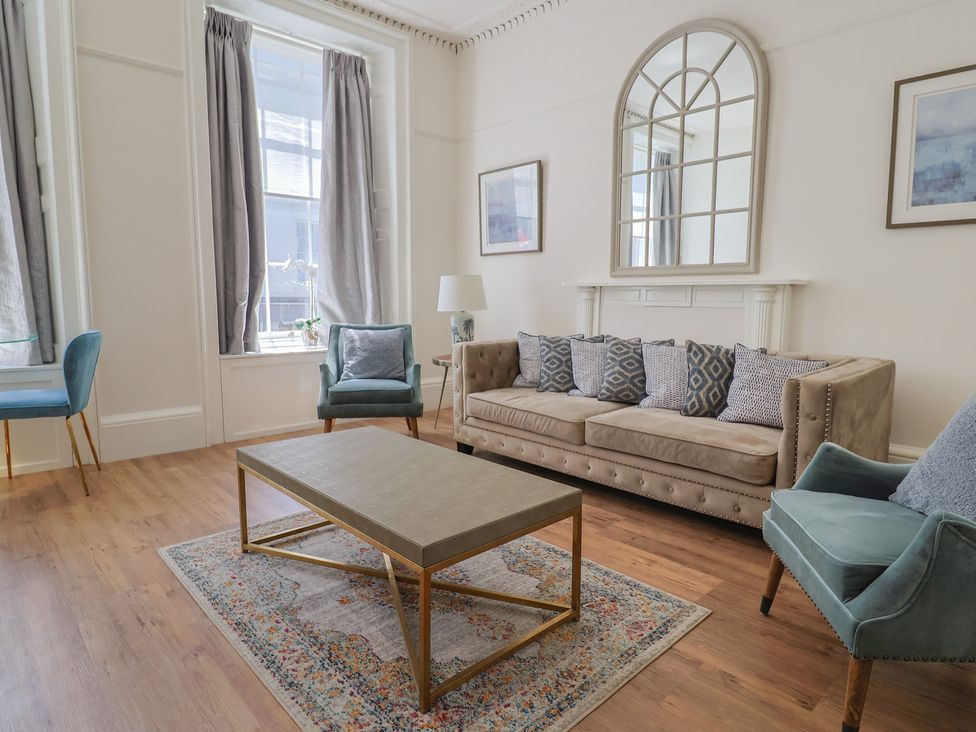A living room with a sofa and coffee table at The Tides in Lyme Regis