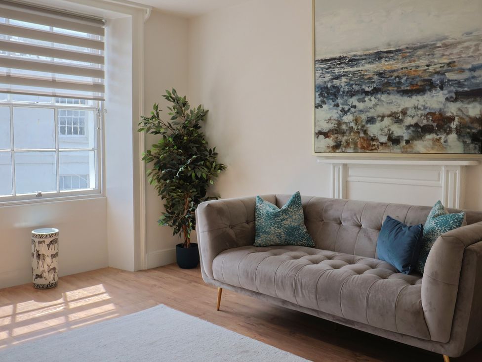 A living room with a couch and artwork at FLAT 2 53a Broad Street (1 Bedroom Sleeping2) Lyme Regis