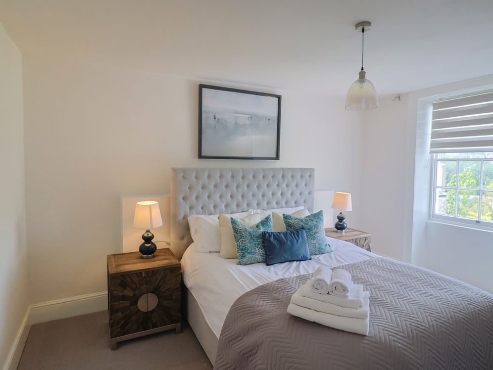 A bedroom with a bed and nightstands at FLAT 2 53a Broad Street (1 Bedroom Sleeping2) Lyme Regis