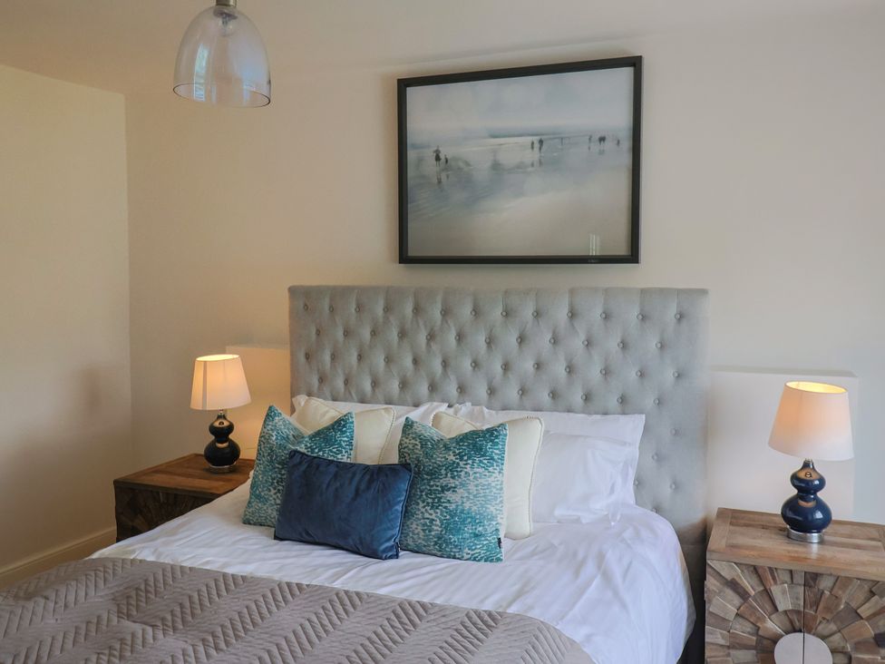 A bedroom with a bed and nightstands at FLAT 2 53a Broad Street (1 Bedroom Sleeping2) Lyme Regis