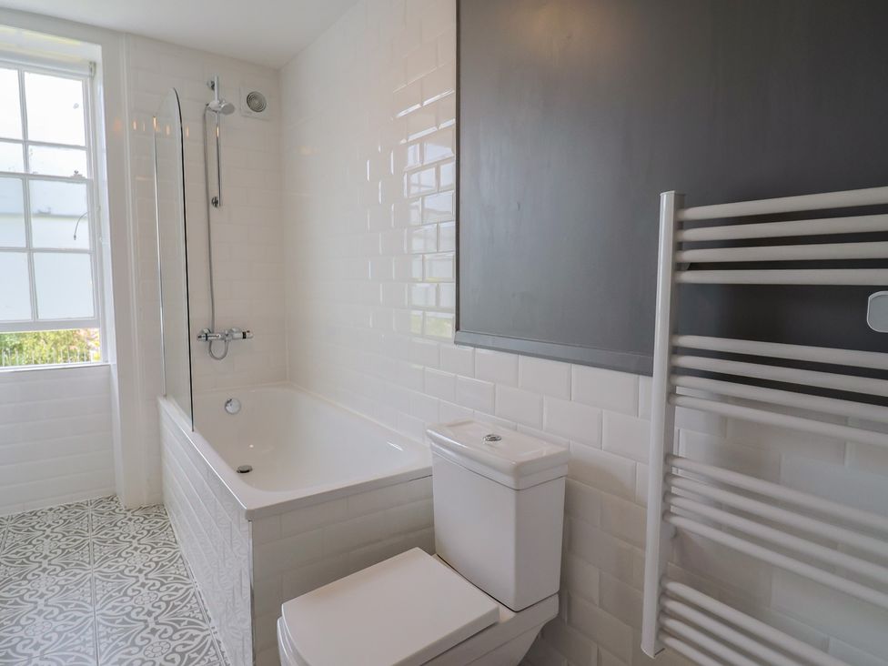 A bathroom with a bathtub and shower at FLAT 2 53a Broad Street (1 Bedroom Sleeping2) Lyme Regis