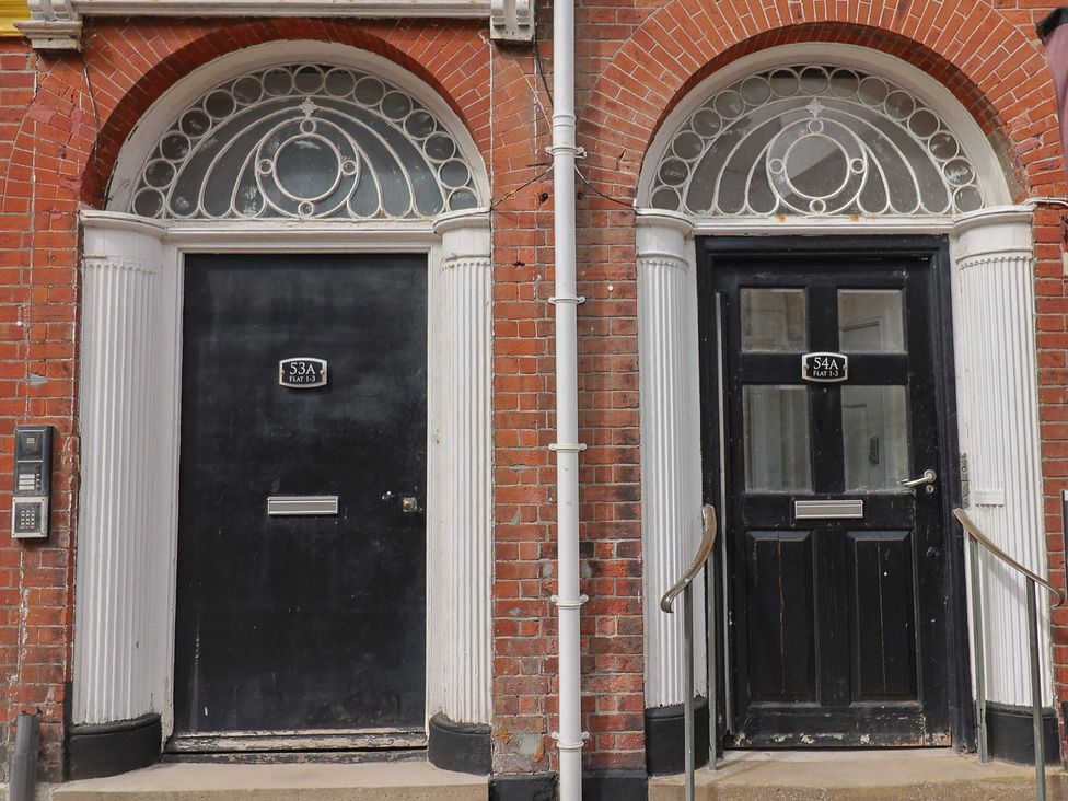 Two black doors with numbers 53A and 54A at Saltwind Lyme Regis