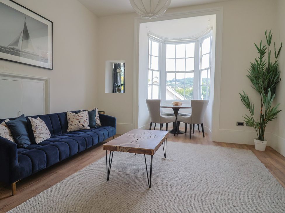A living room with a sofa and coffee table at Saltwind in Lyme Regis