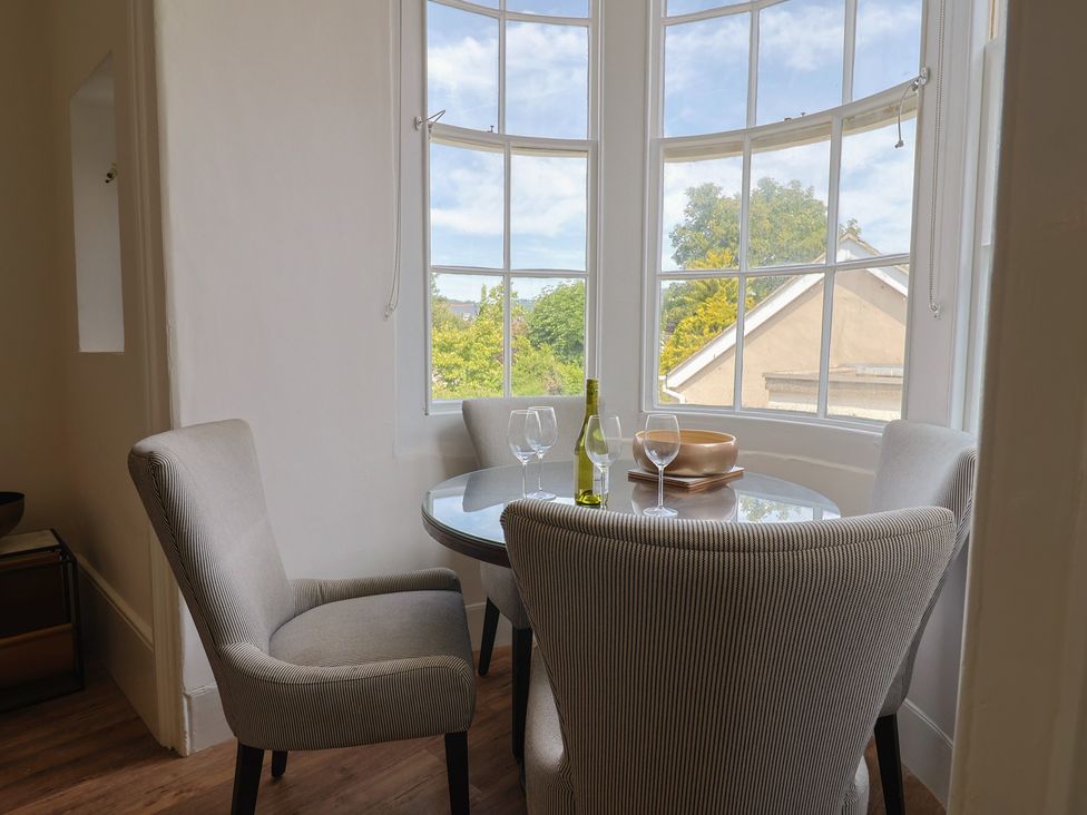 A dining room with a table and chairs at Saltwind in Lyme Regis