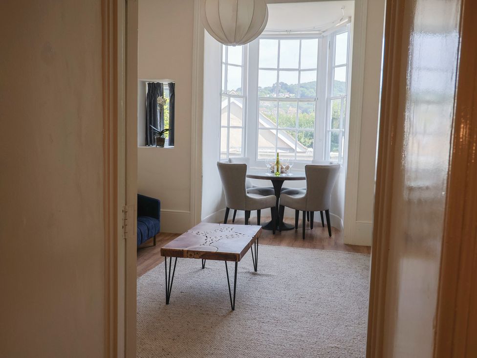 A dining area with a table and chairs at Saltwind in Lyme Regis