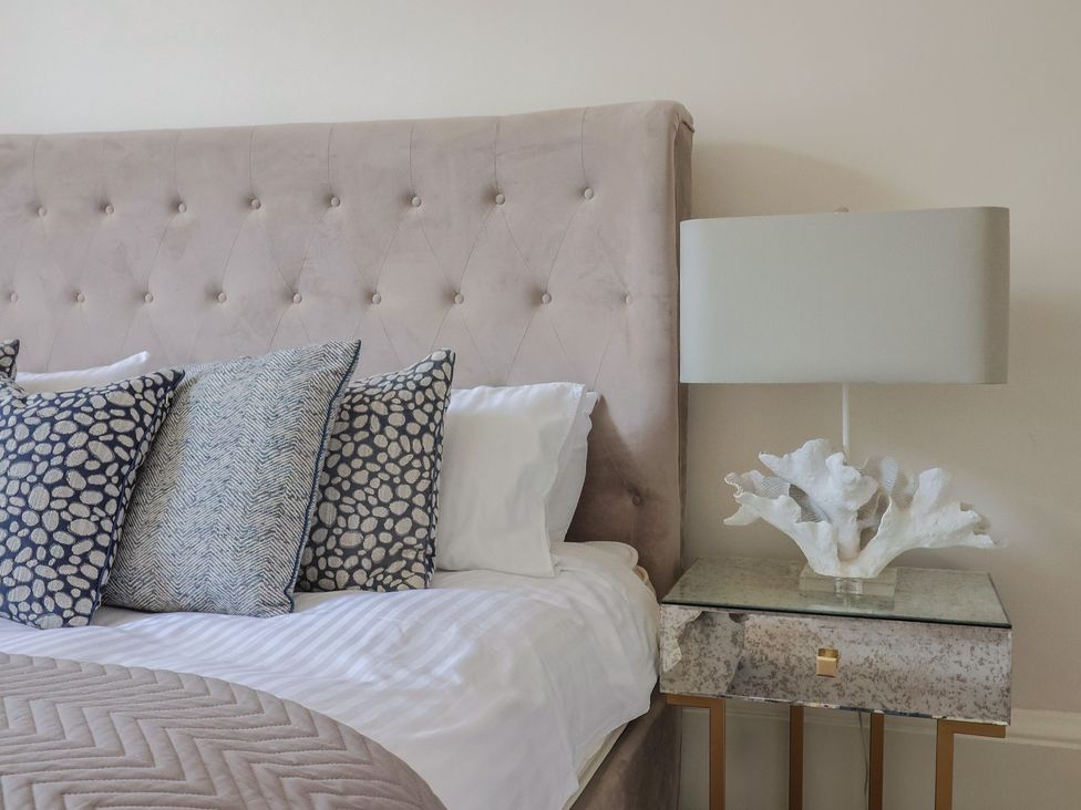 A bedroom with a bed and nightstand at Saltwind in Lyme Regis