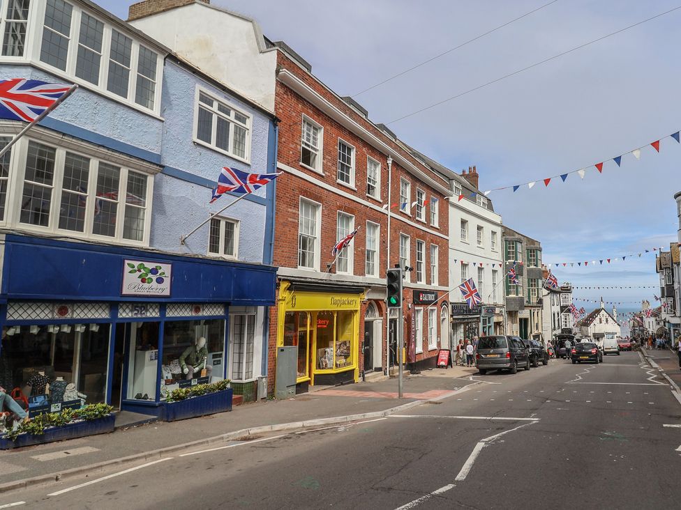 A street with shops and flags at Saltwind in Lyme Regis