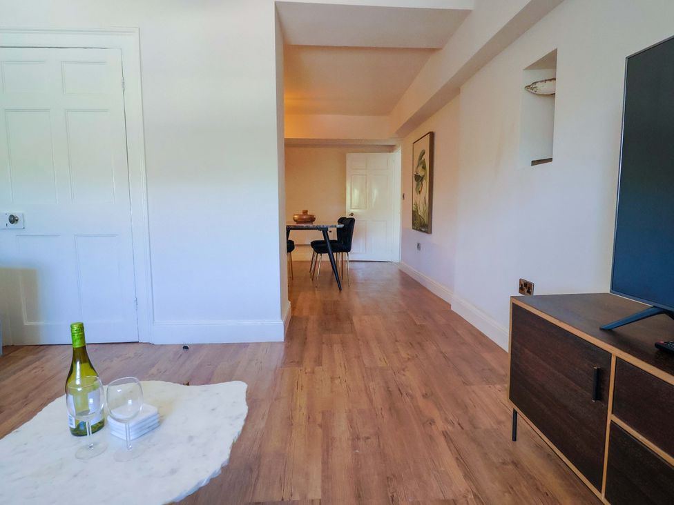 A living room with a table and chairs at Pebble Cove Lyme Regis