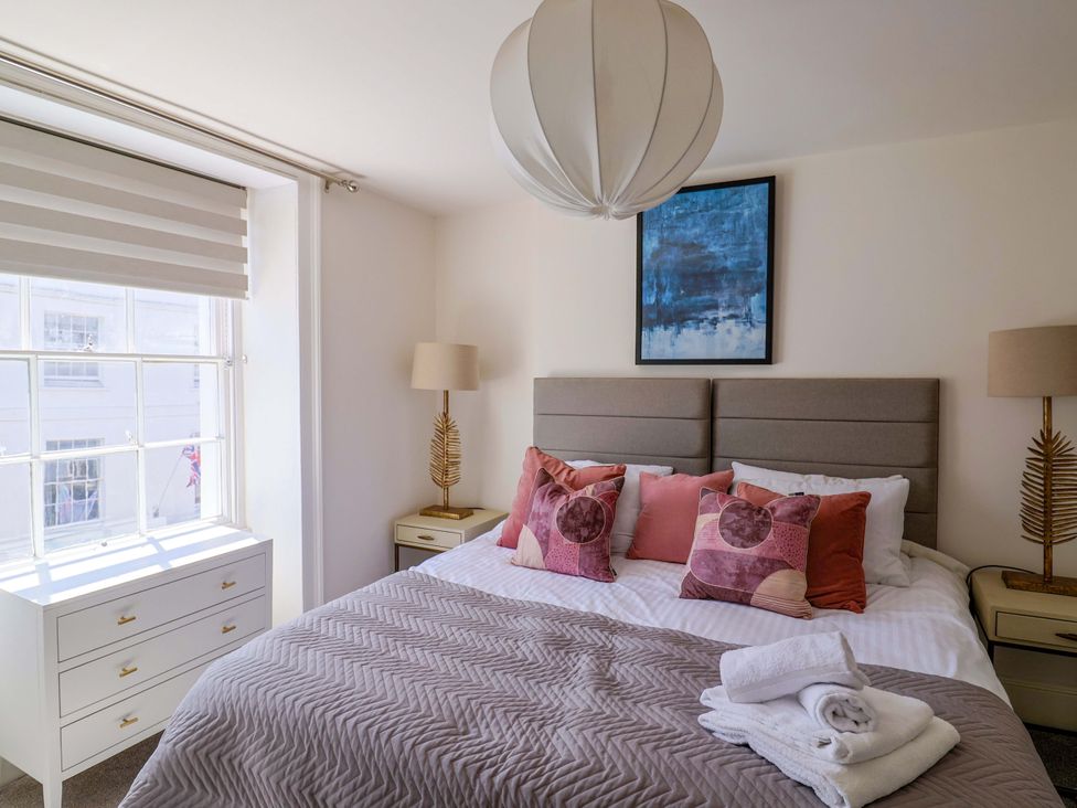 A bedroom with a bed and furniture at Pebble Cove in Lyme Regis