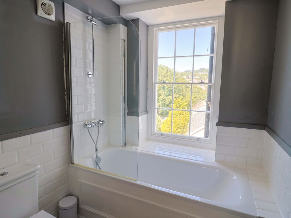 A bathroom with a bathtub and shower at Pebble Cove in Lyme Regis