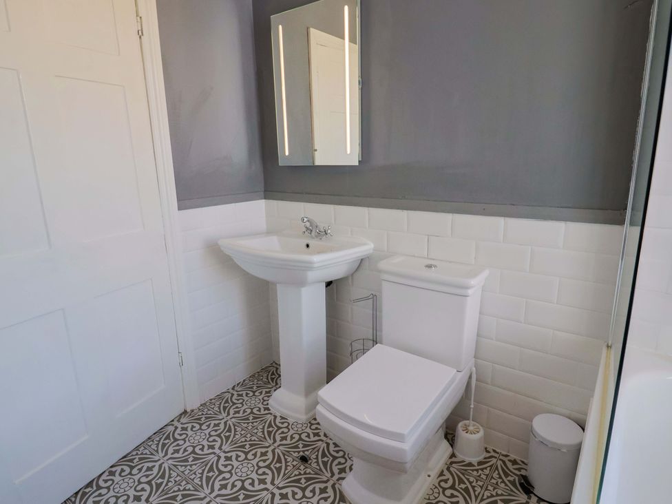 A bathroom with a sink and toilet at Pebble Cove in Lyme Regis