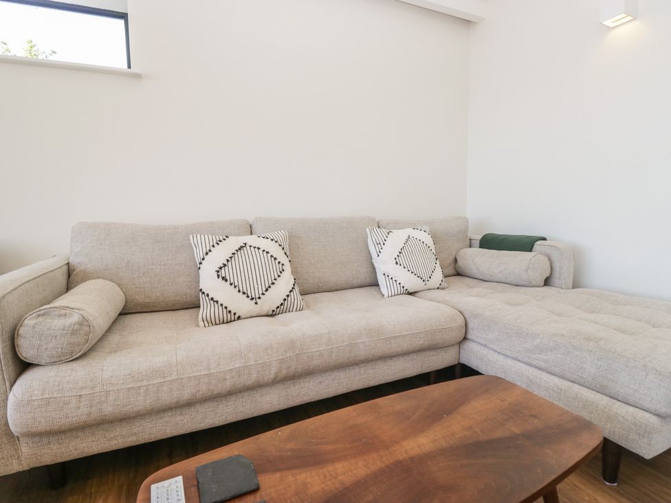 A living room with a sofa and coffee table at Driftwood Cottage in Ulverston