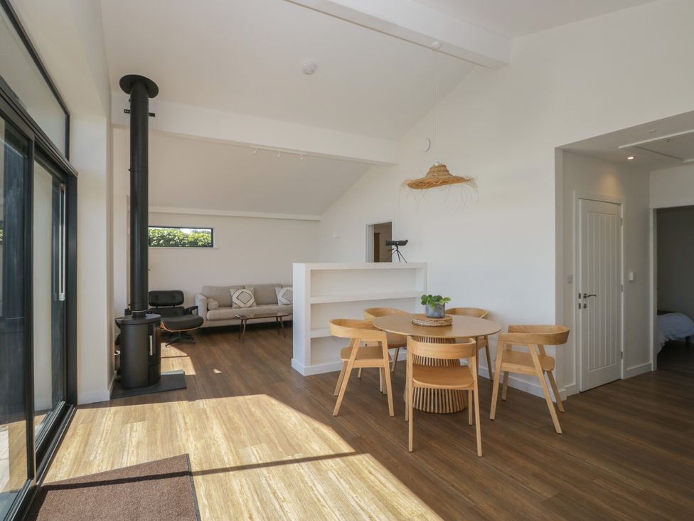 A dining room with a table and chairs at Driftwood Cottage in Ulverston