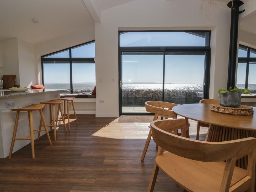 A dining room with a table and chairs at Driftwood Cottage in Ulverston