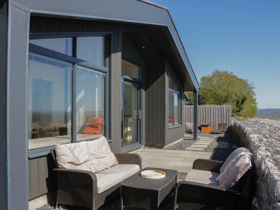 An outdoor seating area with a sofa and table at Driftwood Cottage in Ulverston