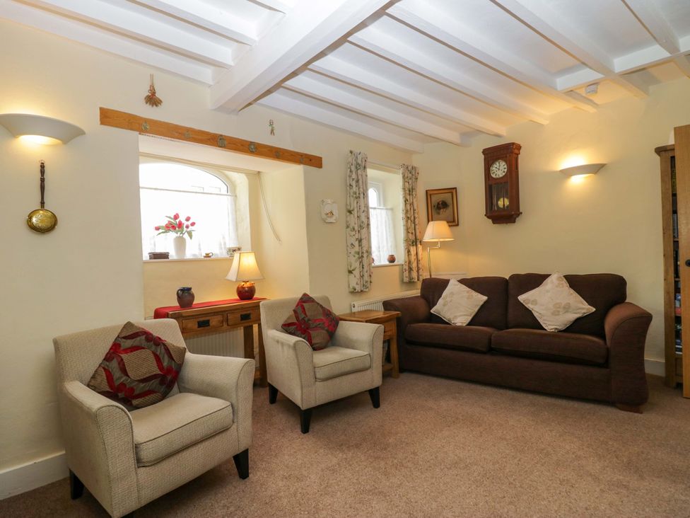 A living room with a sofa and armchairs at Hollens Cottage in Grasmere