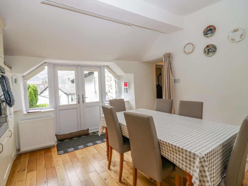 A dining room with a table and chairs at Hollens Cottage in Grasmere