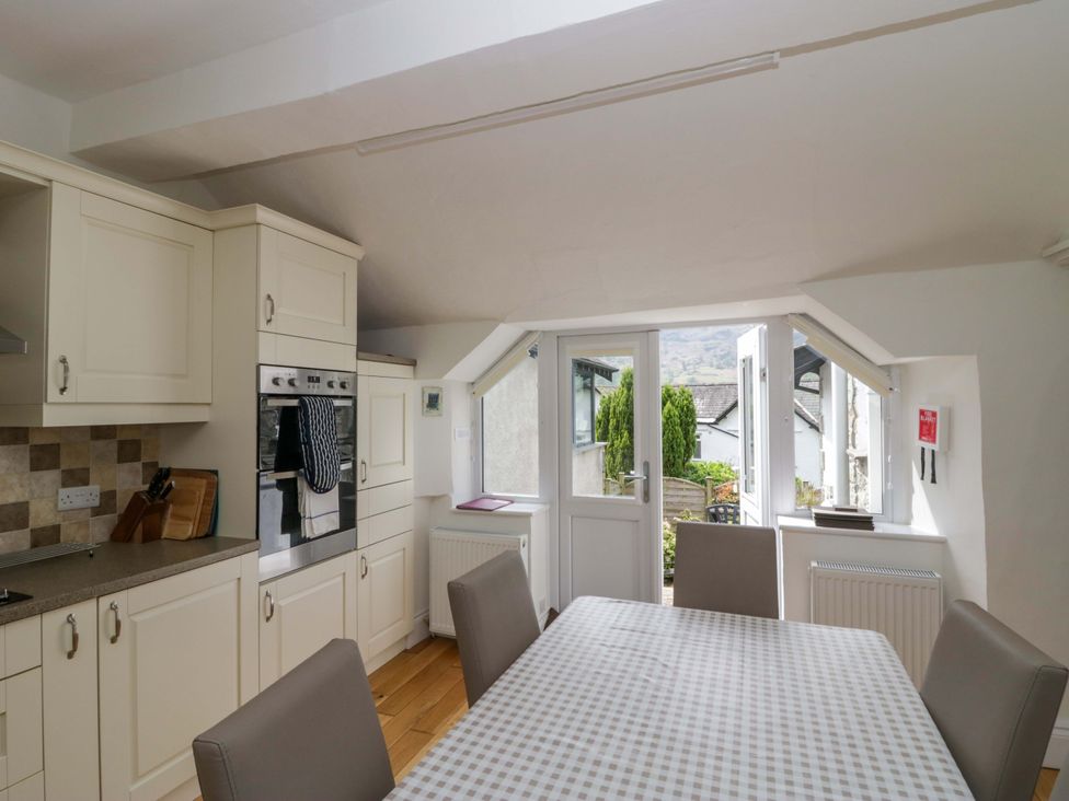A kitchen with a table and chairs at Hollens Cottage in Grasmere