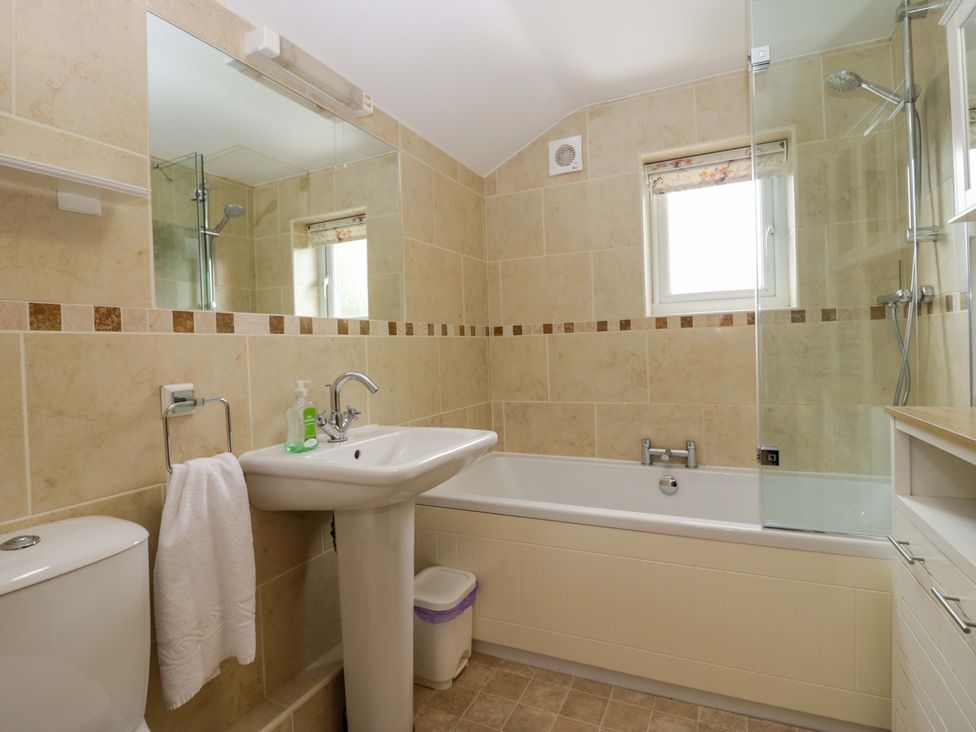 A bathroom with a sink and bathtub at Hollens Cottage in Grasmere