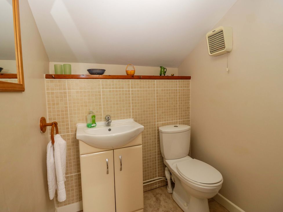 A bathroom with a sink and toilet at Hollens Cottage in Grasmere