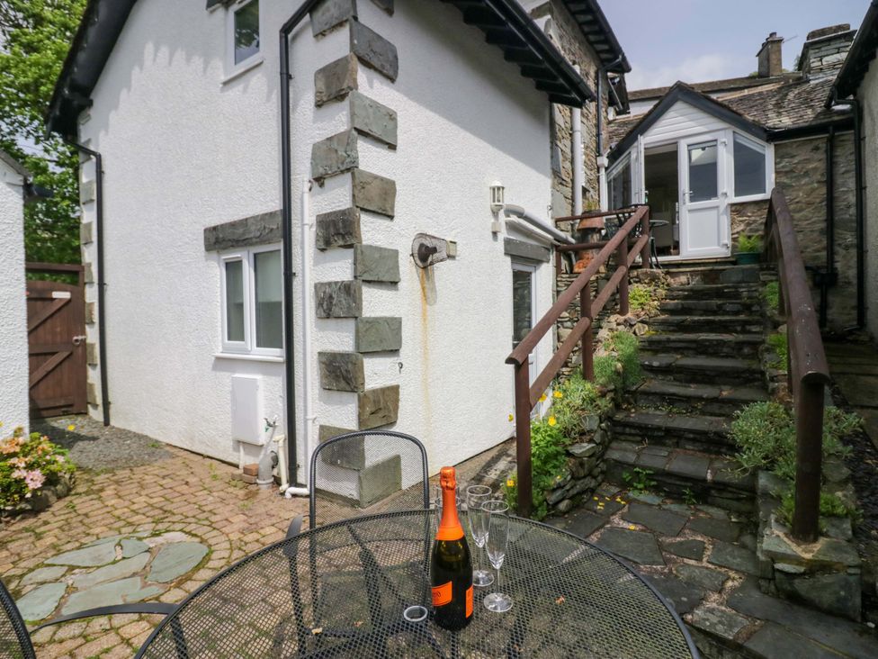 An outdoor area with a table and chairs at Hollens Cottage in Grasmere