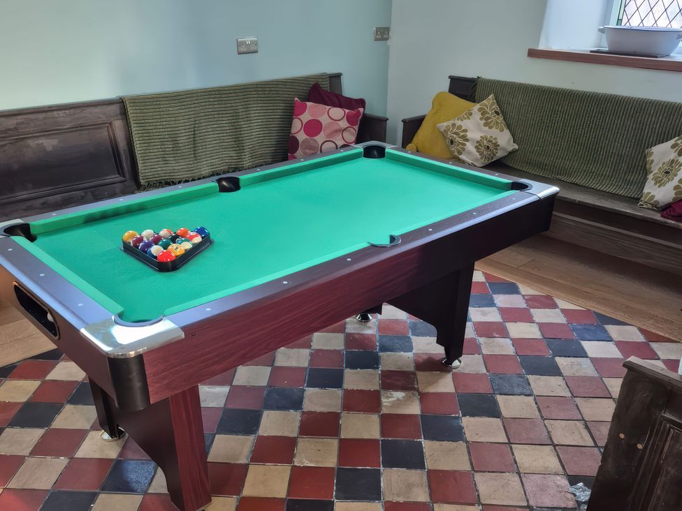 A snug room with a pool table and seating at Church Llygad Y Dyffryn Sarnau near Brynhoffnant
