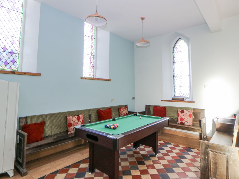 A game room with a pool table and seating at Church Llygad Y Dyffryn in Sarnau near Brynhoffnant